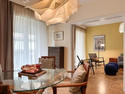 a living room with a glass table and chairs at Athina in Athens 5 min to Metro Station in Athens