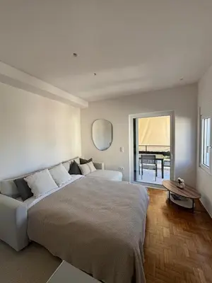 a bedroom with a large bed and a large window at Athens Riviera Sea in Athens