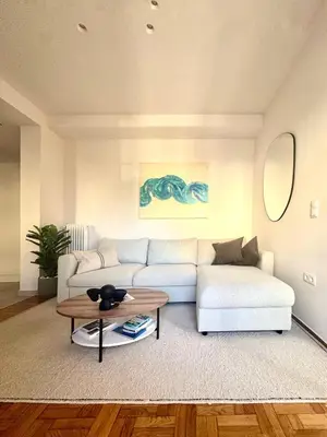 a living room with a white couch and a table at Athens Riviera Sea in Athens