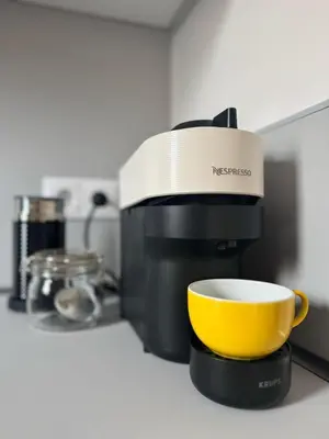 a coffee maker and a yellow cup on a counter at Athens Riviera Sea in Athens