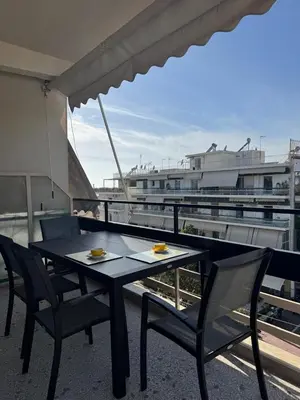 a table and chairs on top of a balcony at Athens Riviera Sea in Athens