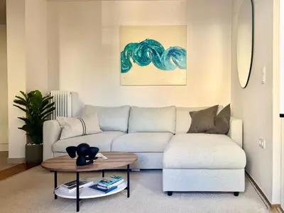 a living room with a couch and a table at Athens Riviera Sea in Athens