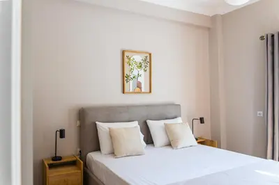 a bedroom with a white bed with white pillows at 3BD Family Comfort Stay in Athens