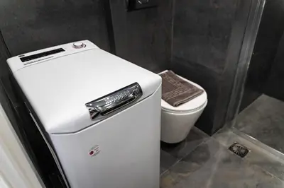 a white refrigerator in a bathroom with a toilet at 3BD Family Comfort Stay in Athens