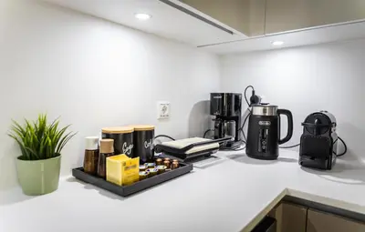 a kitchen counter with a coffeemaker and a coffee maker at 3BD Family Comfort Stay in Athens