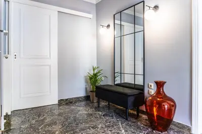 a large red vase sitting next to a mirror at 3BD Family Comfort Stay in Athens