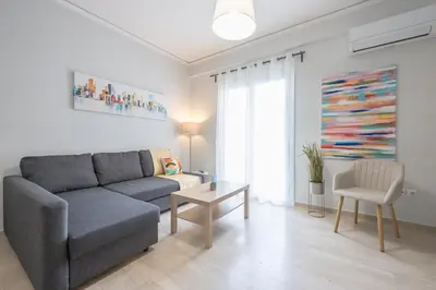 a living room with a couch and a table at Kallithea metro station in Athens