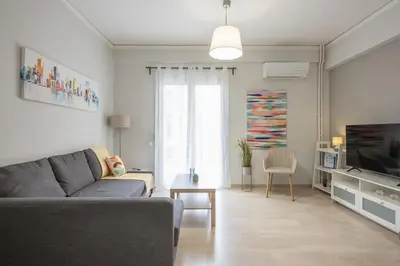 a living room with a couch and a tv at Kallithea metro station in Athens