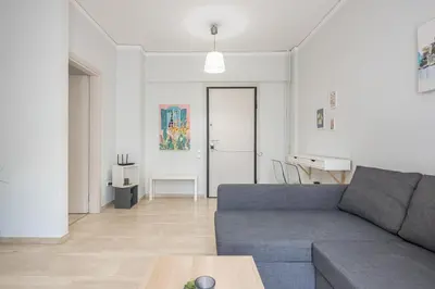 a living room with a couch and a table at Kallithea metro station in Athens