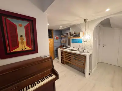 a kitchen with a piano and a painting on the wall at Arthome Acropolis Spot in Athens