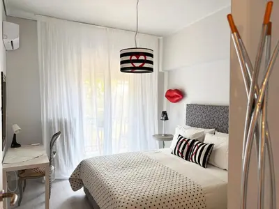 a bedroom with a bed and a desk and a window at Arthome Acropolis Spot in Athens