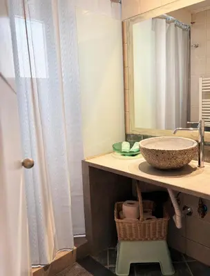 a bathroom with a sink and a mirror at Arthome Acropolis Spot in Athens