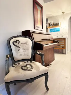 an old chair sitting in front of a piano at Arthome Acropolis Spot in Athens