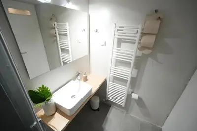 a bathroom with a sink and a mirror at Ilysia's Retreat, Cozy 1 BDRM Apartment in Athens