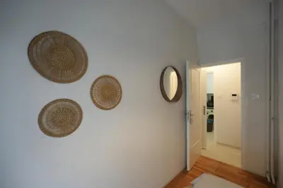 a hallway with three wicker baskets on a wall at Ilysia's Retreat, Cozy 1 BDRM Apartment in Athens