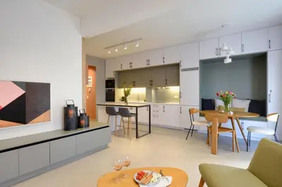 a kitchen and living room with a table and chairs at The Athens Urban Loft in Athens