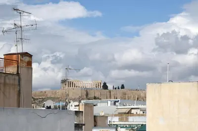 a view of the acropolis from the roofs of buildings at The Athens Urban Loft in Athens