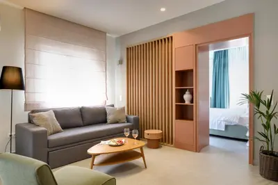 a living room with a couch and a table at The Athens Urban Loft in Athens