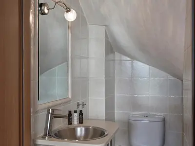 a bathroom with a sink and a toilet at Evi's Voula Home in Athens