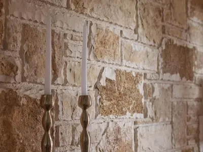two utensils hanging on a brick wall at Evi's Voula Home in Athens