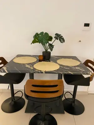 a table with a potted plant on top of it at The Twin Residences in Kallithea in Athens