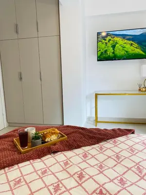 a bedroom with a tray of food on a bed at The Twin Residences in Kallithea in Athens