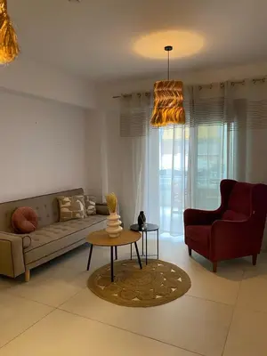 a living room with a couch and a table at The Twin Residences in Kallithea in Athens