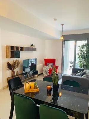 a living room with a table and a couch at The Twin Residences in Kallithea in Athens