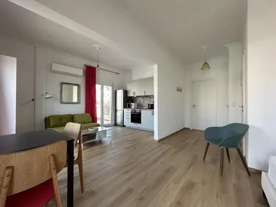 a living room with a dining table and a kitchen at 6th Floor Skyline Suite with Spectacular View in Athens