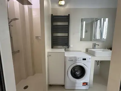 a small bathroom with a washing machine and a sink at 6th Floor Skyline Suite with Spectacular View in Athens