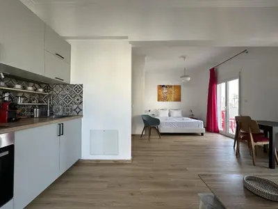a kitchen and a living room with a bed in a room at 6th Floor Skyline Suite with Spectacular View in Athens
