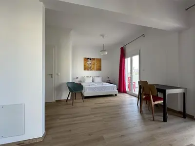 a bedroom with a bed and a table and chairs at 6th Floor Skyline View Studio 1 in Athens in Athens