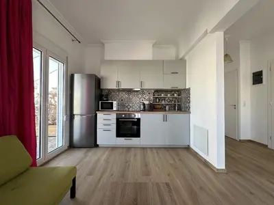 a kitchen with white cabinets and a refrigerator at 6th Floor Skyline View Studio 1 in Athens in Athens