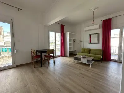a living room with a green couch and a table at 6th Floor Skyline View Studio 1 in Athens in Athens