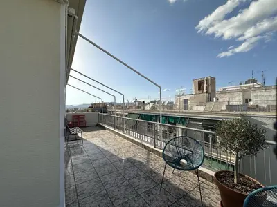 a balcony with chairs and a view of a city at 6th Floor Skyline View Studio 1 in Athens in Athens