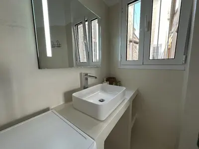a white bathroom with a sink and a mirror at 6th Floor Skyline View Studio 2 in Athens in Athens