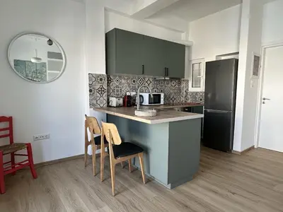 a kitchen with a counter and a black refrigerator at 6th Floor Skyline View Studio 2 in Athens in Athens