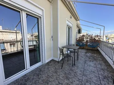 a patio with a table and chairs on a balcony at 6th Floor Skyline View Studio 2 in Athens in Athens