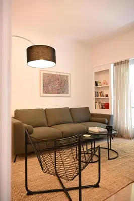 a living room with a couch and a table at Brand new 3bedroom athenian flat in Koukaki in Athens