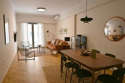 a living room with a table and a couch at Pristine 3 bedroom Luxury Sanctuary! in Athens