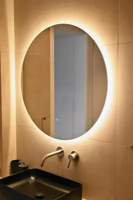 a bathroom with a sink and a round mirror at Pristine 3 bedroom Luxury Sanctuary! in Athens