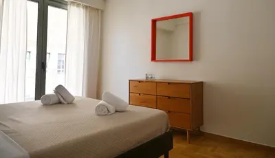 a bedroom with a bed and a dresser and a mirror at Pristine 3 bedroom Luxury Sanctuary! in Athens