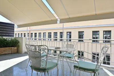 a patio with a table and chairs on a balcony at Pristine 3 bedroom Luxury Sanctuary! in Athens