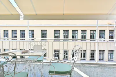 a table and chairs on a balcony with a building at Pristine 3 bedroom Luxury Sanctuary! in Athens