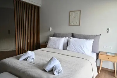 a bedroom with a large bed with towels on it at Luxury Sanctuary- Amazing Sea View - Beach Access in Athens