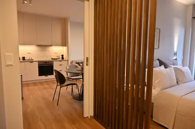 a room with a bed and a table and a kitchen at Luxury Sanctuary- Amazing Sea View - Beach Access in Athens