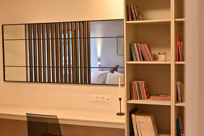 a tv on a wall in a book shelf at Luxury Sanctuary- Amazing Sea View - Beach Access in Athens