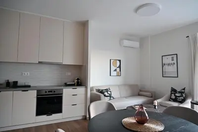 a kitchen and a living room with a table at Luxury Sanctuary- Amazing Sea View - Beach Access in Athens