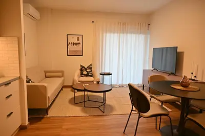 a living room with a couch and a tv at Luxury Sanctuary- Amazing Sea View - Beach Access in Athens