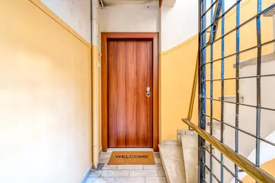 a wooden door in a building with stairs at Elegant Intimate Studio in Piraeus near Pasalimani in Piraeus